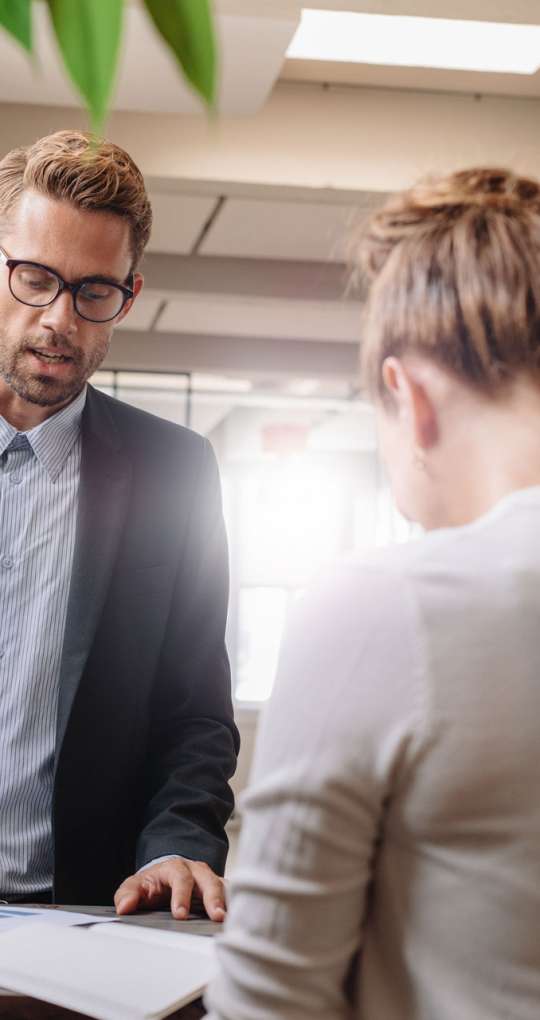 Businessman explaining new business strategy to colleagues. Group of business people having meeting in modern office.